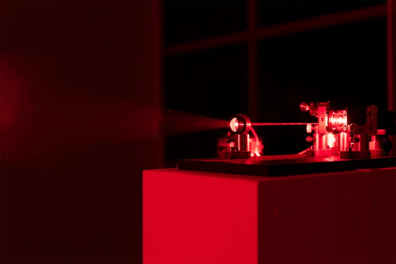 Exceptional Point — red laser and optical apparatus on a pedestal