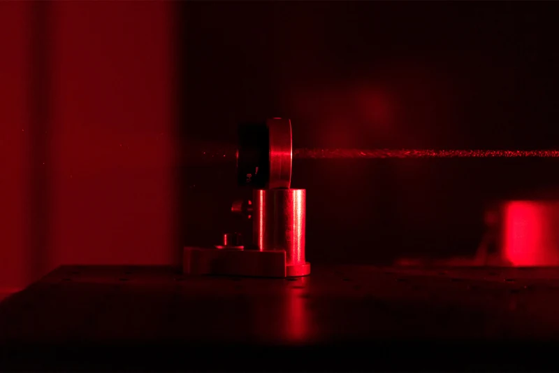 Exceptional Point — close-up of the lens and red laser beam